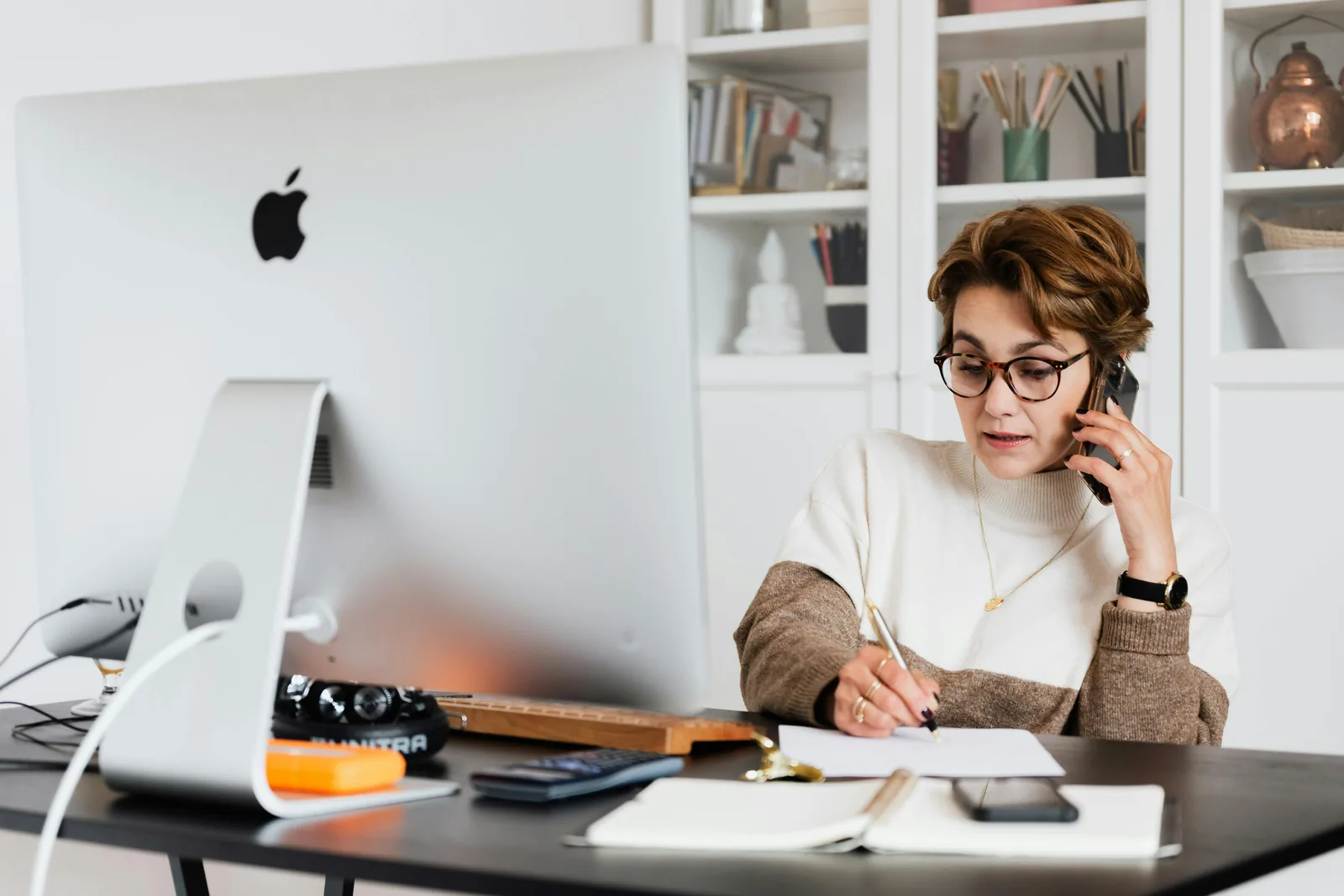Freelancer using a laptop while working through support and project details.